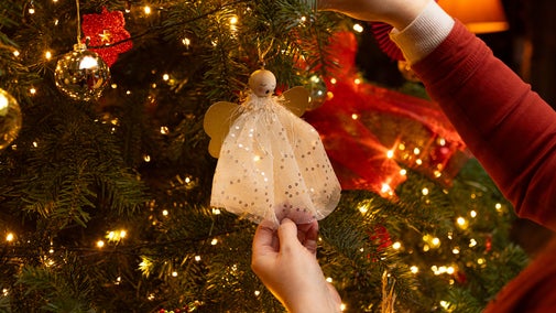 A fairy angel sings on a decorated tree at Baddesley Clinton